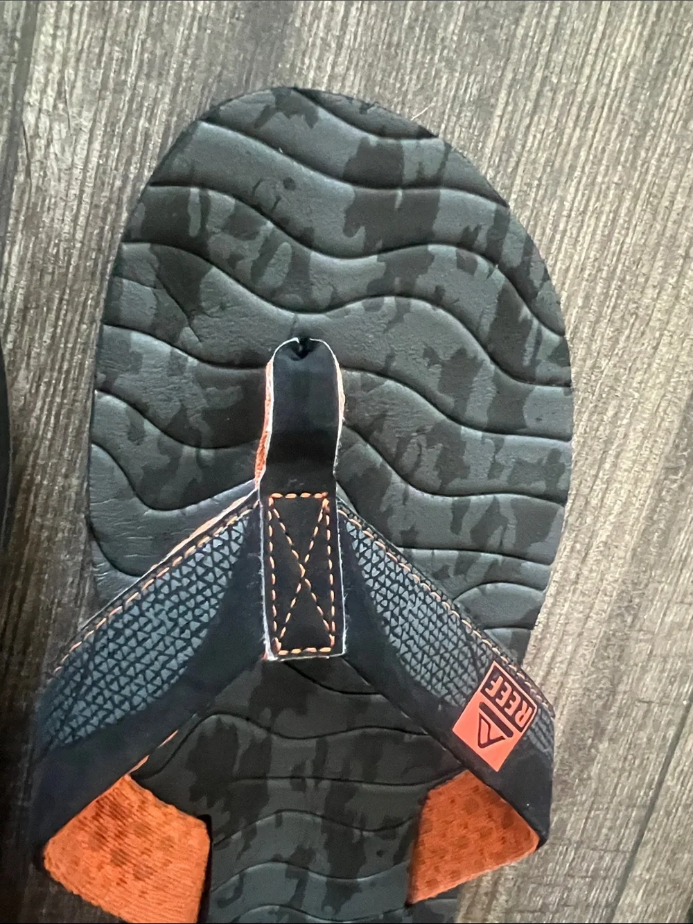 Reef Roundhouse Flip Flops in orange and black